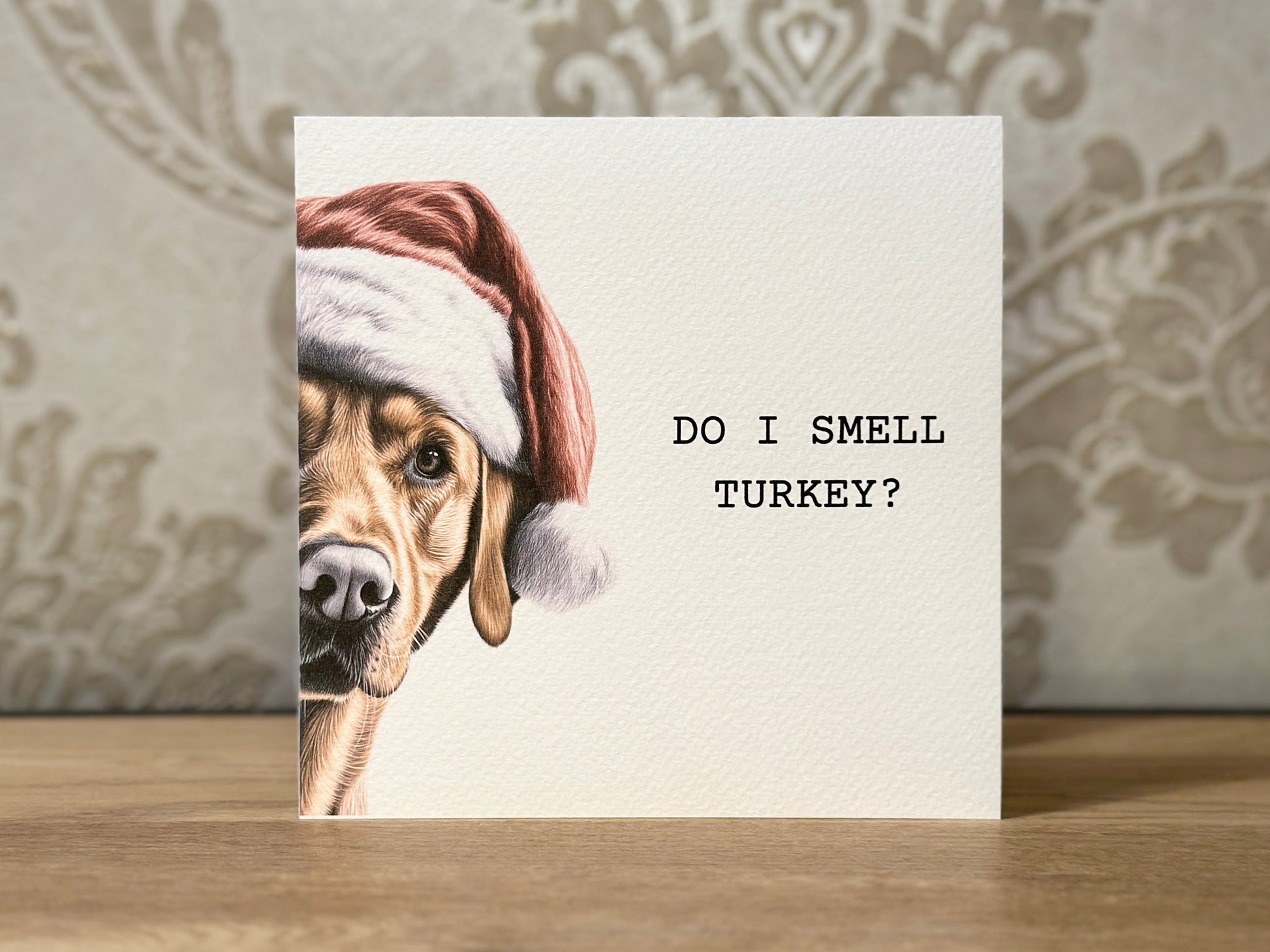 Card with a dog wearing a Santa hat and text 'Do I smell turkey?'