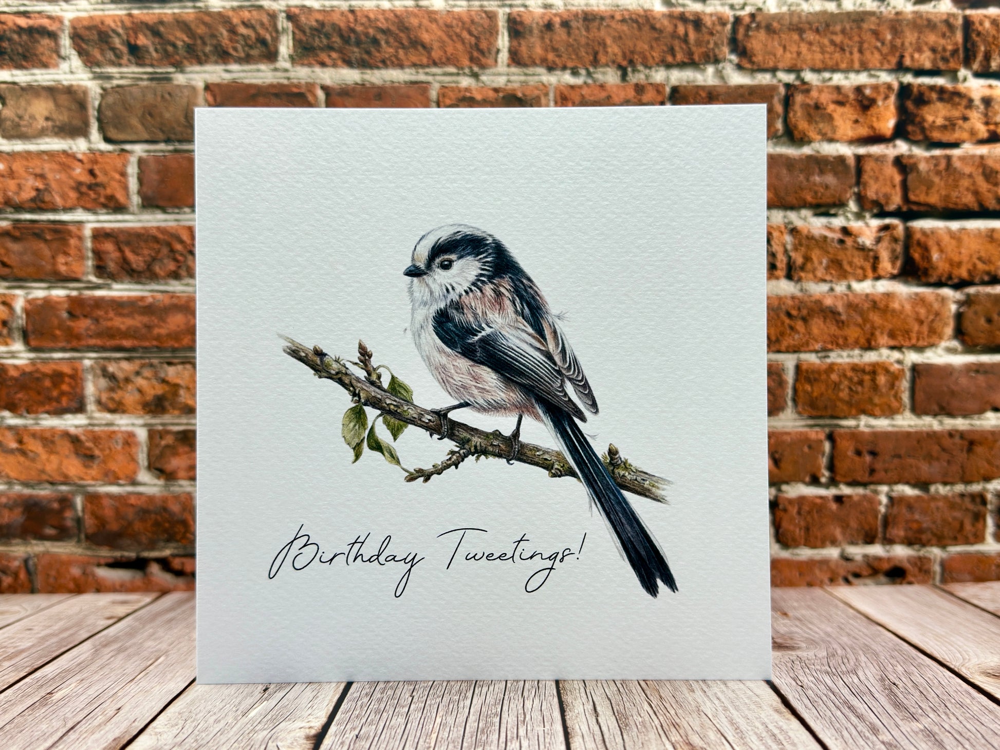 Card with a Long Tailed Tit illustration and 'Birthday Tweetings!' text against a brick wall background